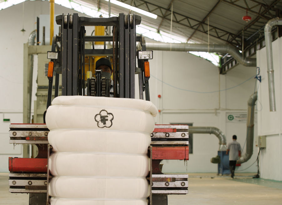 A forklift with a stack of white material
AI-generated content may be incorrect.